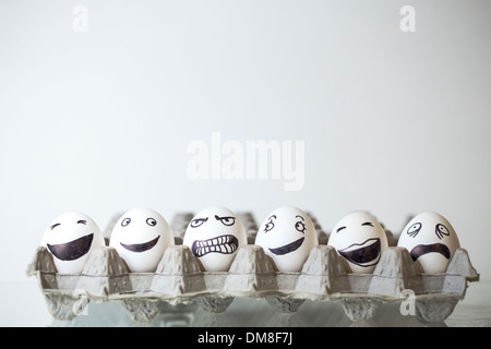 Row of eggs with painted on faces Stock Photo