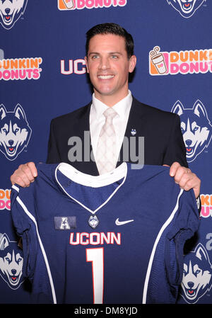 Storrs, CT, USA. 12th Dec, 2013. Thursday December 12, 2013: Bob Diaco poses for photos holding a UConn jersey after the press conference to announce his hiring as the new UConn Huskies football coach at Shenkman Training Center in Storrs, CT. Bill Shettle / Cal Sport Media. © csm/Alamy Live News Stock Photo