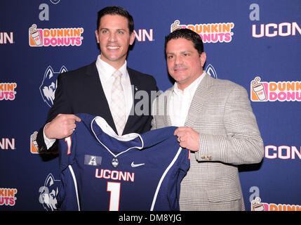 Storrs, CT, USA. 12th Dec, 2013. Thursday December 12, 2013: Bob Diaco poses for photos with his brother Frank holding a UConn jersey after the press conference to announce his hiring as the new UConn Huskies football coach at Shenkman Training Center in Storrs, CT. Bill Shettle / Cal Sport Media. © csm/Alamy Live News Stock Photo