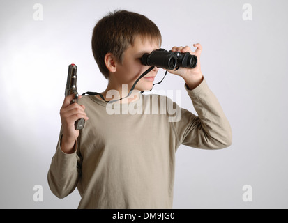 Child with a gun and binoculars Stock Photo