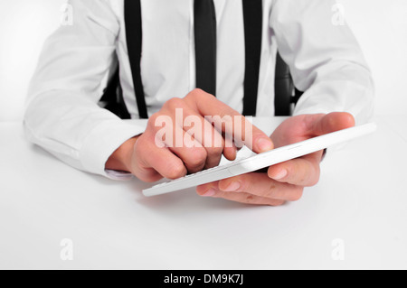 a businessman sitting in a desk using a tablet computer Stock Photo