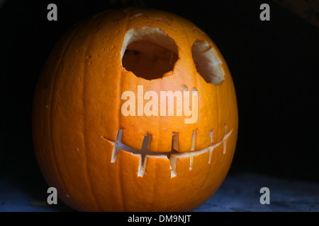 Halloween Pumpkin on back background with cut out face. Stock Photo