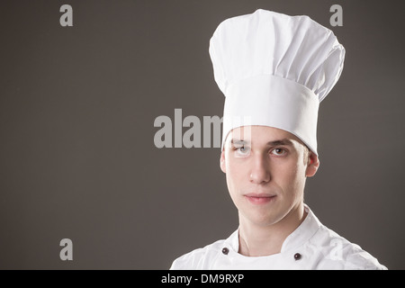 Portrait of smiling chef isolated on grey background Stock Photo