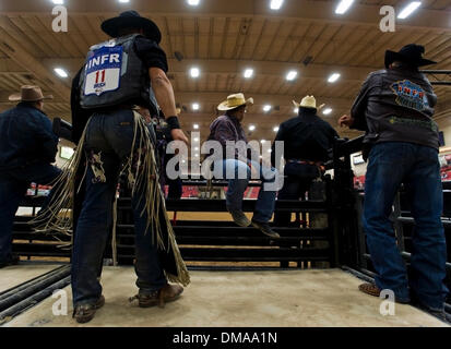 Nov. 12, 2009 - Las Vegas, Nevada, USA -  Cowboys watch the action in the arena at the South Point Equestrian Center, site of the Indian National Finals Rodeo.  The INFR is the culmination of the rodeo year for the 350 Native American and Canadian contestants who qualified in regional and tour events to compete for championship titles in bareback riding, saddle bronc riding, bull r Stock Photo