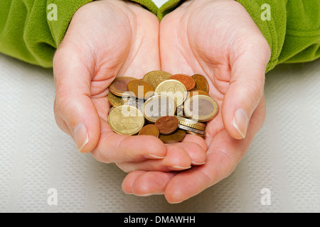 Close up of man person hands holding Euro euros coins cash money EU Europe European Stock Photo