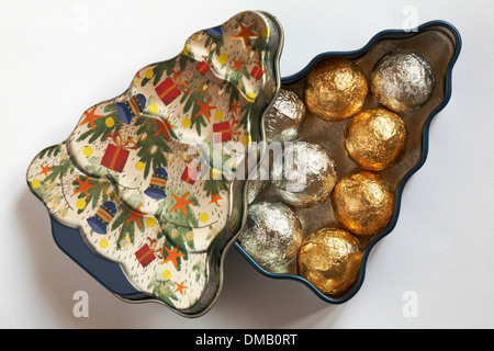 Christmas tree tin with foil covered chocolate balls  - chocolates ready for Christmas isolated on white background Stock Photo