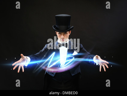 magician in top hat showing trick Stock Photo