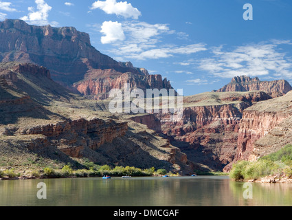Several rafts floating down a serene and calm section of the Grand Canyon. Stock Photo