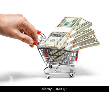 Hand pushing shopping cart full of stacks of dollar bills Stock Photo
