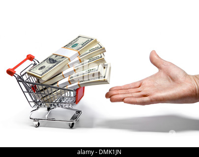 Hand offers shopping cart full of money stacks Stock Photo