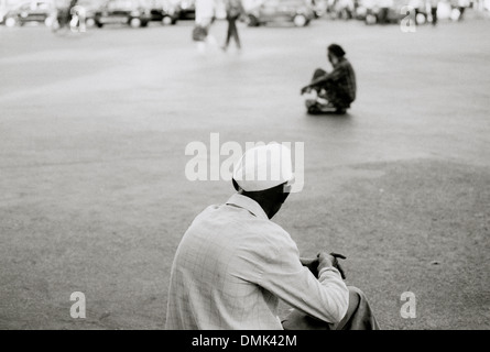 Man wearing the Gandhi Cap in outside Victoria Terminus Chhatrapati Shivaji in Mumbai Bombay in Maharashtra in India in South Asia. Solitude Indian Stock Photo