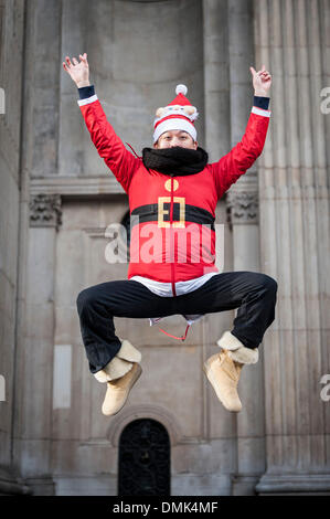 London, UK. 14th December, 2013.  A tourist participating in this year's Sanatcon.  Hundreds of Santas gather on the steps of St Pauls Cathedral before they march off to meet up with groups of other Santas to celebrate the annual Santacon.  Photographer: Gordon Scammell/Alamy Live News Stock Photo