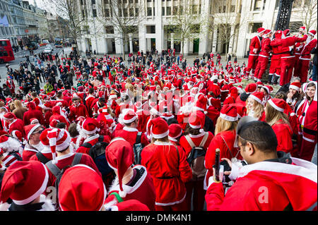 London, UK. 14th December, 2013.  Hundreds of Santas gather on the steps of St Pauls Cathedral before they march off to meet up with groups of other Santas to celebrate the annual Santacon.  Photographer: Gordon Scammell/Alamy Live News Stock Photo