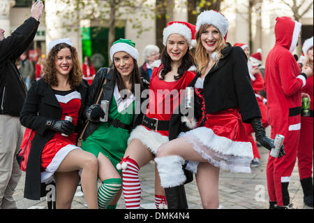 London, UK. 14th December, 2013.  Four girls having fun at this year's Santacon.  Hundreds of Santas gather on the steps of St Pauls Cathedral before they march off to meet up with groups of other Santas to celebrate the annual Santacon.  Photographer: Gordon Scammell/Alamy Live News Stock Photo