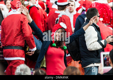 London, UK. 14th December, 2013.  Hundreds of Santas gather on the steps of St Pauls Cathedral before they march off to meet up with groups of other Santas to celebrate the annual Santacon.  Photographer: Gordon Scammell/Alamy Live News Stock Photo