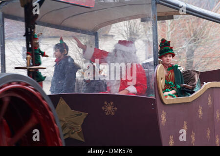 Wimborne, Dorset, UK. 14th December 2013. Crowds turn out to watch the 25th Wimborne Save The Children Christmas Parade. Father Christmas, Santa Claus, with his helper Elf. Credit:  Carolyn Jenkins/Alamy Live News Stock Photo