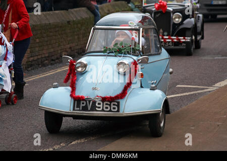 Wimborne, Dorset, UK. 14th December 2013. Crowds turn out to watch the 25th Wimborne Save The Children Christmas Parade. Messerschmitt Kr200 Bubble Top three wheel car  decorated with driver dressed as Santa. Credit:  Carolyn Jenkins/Alamy Live News Stock Photo
