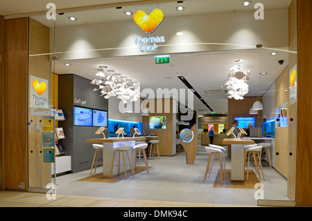 Interior view of Thomas Cook travel agents premises open plan entrance at indoor shopping mall new 'Sunny Heart' corporate logo rebranding England UK Stock Photo