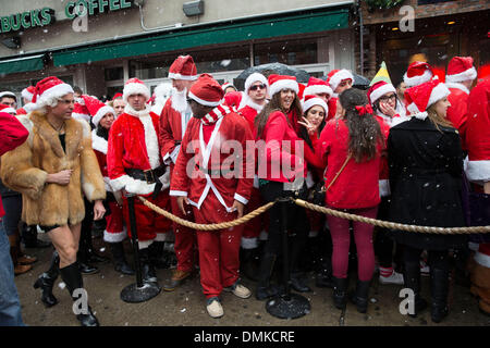 New York, USA. 14th Dec 2013. Revelers participating in SantaCon gather in New Yorks lower East Side where many drink in bars. The SantaCon annual event occurs in more than 300 cities in 44 countries. In New York some parts of the city have established a ' Santa Free, ' zone that urges bars not to serve  alcohol to SantaCon participants due to past unruly and drunken behavior. Credit:  Scott Houston/Alamy Live News Stock Photo