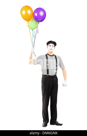 Full length portrait of a young mime artist holding balloons and looking at camera Stock Photo