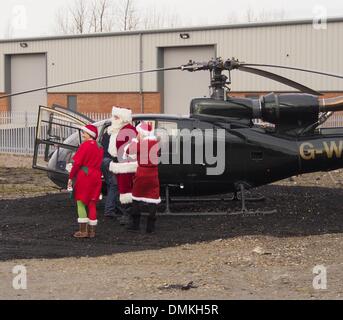 Leyland, Preston, Lancashire, UK. 15th Dec 2013. Santa arrives by helicopter at Avant garden centre. © Sue Burton/Alamy Live News Stock Photo