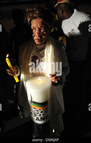 Soweto, South Africa. 15th Dec 2013. People hold a night vigil for former President Nelson Mandela in Vilakazi Street on December 15, 2013 in Soweto, South Africa. 15th Dec 2013. Nelson Mandela passed away on the evening of December 5, 2013 at his home. He is laid to rest at his homestead in Qunu during a State Funeral. (Photo by Gallo Images / City Press / Lucky Nxumalo) Credit:  Gallo images/Alamy Live News Stock Photo