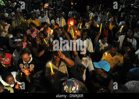 Soweto, South Africa. 15th Dec 2013. People during a night vigil for former President Nelson Mandela in Vilakazi Street on December 13, 2013 in Soweto, South Africa. 15th Dec 2013. Nelson Mandela passed away on the evening of December 5, 2013 at his home. He is laid to rest at his homestead in Qunu during a State Funeral. (Photo by Gallo Images / City Press / Lucky Nxumalo) Credit:  Gallo images/Alamy Live News Stock Photo