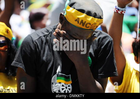 Soweto, South Africa. 15th Dec 2013. Thousands of people gathered to pay their last respects to Nelson Mandela at Orlando Stadium while he was buried in Qunu on December 15, 2013 in Soweto, South Africa. Nelson Mandela passed away on the evening of December 5, 2013 at his home. He is laid to rest at his homestead in Qunu today. (Photo by Gallo Images / Foto24 / Mary-Ann Palmer) Credit:  Gallo images/Alamy Live News Stock Photo