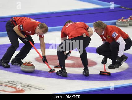 Fuessen, Germany. 14th Dec, 2013. The German curler Sven Goldemann (L-R), Christopher Bartsch and John Jah play during the game for the qualification for the olympics at the Arena in Fuessen, Germany, 14 December 2013. Photo: Karl-Josef Hildenbrand/dpa/Alamy Live News Stock Photo