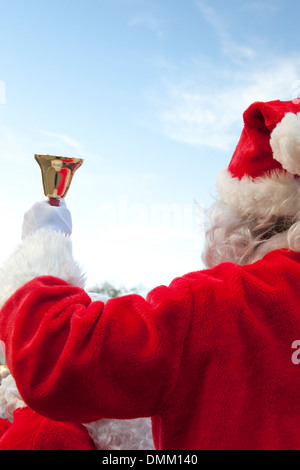 traditional Santa Claus ringing on a bell, concept coming Christmas ...