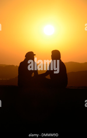 Lovers sitting on the wall at Skala du Port close to Medina Essaouira Morocco Stock Photo