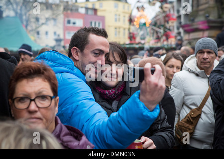 Christmas Market Cologne man making a selfie self portrait of himself and his wife Stock Photo