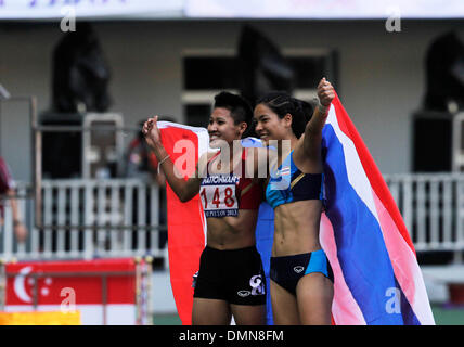 Nay Pyi Taw, Myanmar. 16th Dec, 2013. Treewadee Yongphan (L) of Thailand, the gold medal winner of women's 400m final and Sukanya Chomchuendee of Thailand, the gold medal winner of Athletics women's pole vault final, celebrate during 27th SEA Games at Nay Pyi Taw's Wunna Theikdi Stadium, Myanmar, Dec. 15, 2013. © Thet Htoo/Xinhua/Alamy Live News Stock Photo