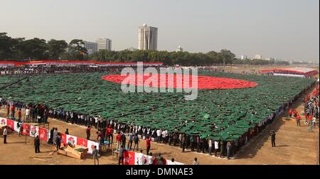 Dhaka, Bangladesh. 16th Dec, 2013. Members of Bangladesh Army, Defense officials and schoolchildren form the world's largest human national flag to mark the country's Victory Day in Dhaka on December 16, 2013. A total of 27,117 volunteers, mostly students, used coloured tiles to form the flag at Dhaka's National Parade Ground. Bangladesh won independence from Pakistan after a bitter nine-month war in 1971 led by the country's founder Sheikh Mujibur Rahman, and this is celebrated every year on December 16. Credit:  Monirul Alam/ZUMAPRESS.com/Alamy Live News Stock Photo