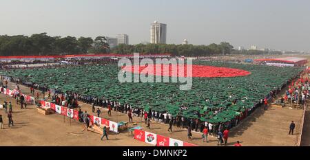 Dhaka, Bangladesh. 16th Dec, 2013. Members of Bangladesh Army, Defence officials and schoolchildren form the world's largest human national flag to mark the country's Victory Day in Dhaka. A total of 27,117 volunteers, mostly students, used coloured tiles to form the flag at Dhaka's National Parade Ground. Bangladesh won independence from Pakistan after a bitter nine-month war in 1971 led by the country's founder Sheikh Mujibur Rahman, and this is celebrated every year on December 16. © Monirul Alam/ZUMAPRESS.com/Alamy Live News Stock Photo