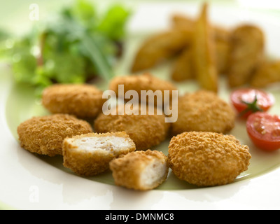 chicken pieces tomatoes salad chips batter Stock Photo