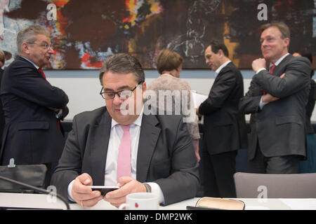 Berlin, Germany. 16th Dec, 2013. Chairman of the SPD Sigmar Gabriel attends a parliamentary group meeting of the SPD at the Bundestag in Berlin, Germany, 16 December 2013. Designated parliamentary group leader in the German 'Bundestag' parliament of the SPD Thomas Oppermann (BACK.R) and deputy parliamentary group leader of the SPD Joachim Poss (BACK-L) are seenin the background. Photo: MAURIZIO GAMBARINI/dpa/Alamy Live News Stock Photo