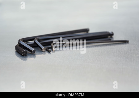 Group of hexagonal wrenches (Allen Keys) on a metal work bench. Stock Photo
