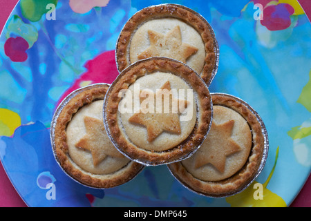 close up of mince pies with stars on, on colourful plate ready for Christmas Stock Photo