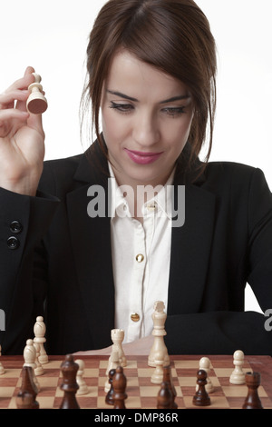 Beautiful Brunette Woman Playing Chess Stock Photo