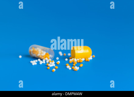 open medicine capsule granules vitamins Stock Photo