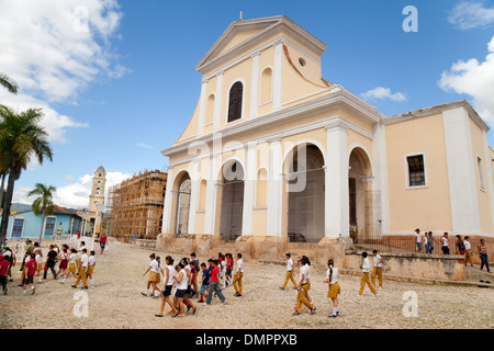 Schoolchildren in front  Church of the Holy Trinity, Trinidad town centre, UNESCO World Heritage site, Cuba Caribbean Stock Photo