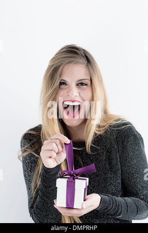 happy young woman opening gift Stock Photo
