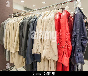 Genuine ladies leather jackets hanging on a rail in shop Stock Photo