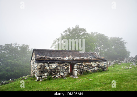 stone house in countryside in foggy day Stock Photo