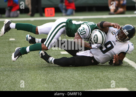 Jaguars #9 quarterback David Garrard tackled by Jets #30 Drew Coleman  before he can get the