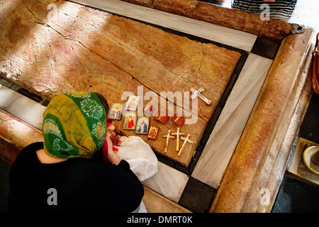 The Stone of Anointing, also known as The Stone of Unction inside the Church of the Holy Sepulchre. Stock Photo