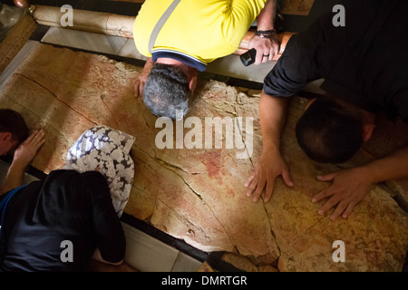 The Stone of Anointing, also known as The Stone of Unction inside the Church of the Holy Sepulchre. Stock Photo