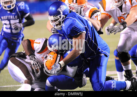 Bowling Green running back Willie Geter (1) is tackled by Buffalo defensive back Josh Thomas (15) and Buffalo defensive lineman Steven Means (40) in the third quarter. Buffalo lost the game to Bowling Green 30-29 Tuesday night at UB Stadium in Buffalo, NY. (Credit Image: © Michael Johnson/Southcreek Global/ZUMApress.com) Stock Photo