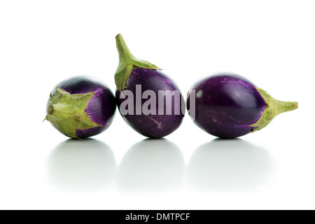 Three eggplants in a row isolated on white background Stock Photo